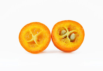 Fresh kumquat fruit cut in half, white background