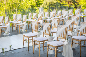 A beautiful wedding ceremony with flowers on the terrace at sunset