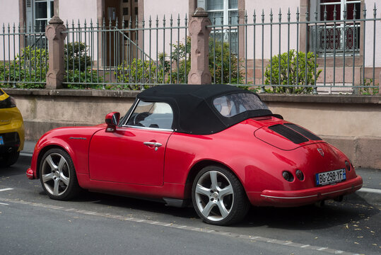 Colmar - France - 30 April 2023 - Profile view of red pgo roadster car parked in the street