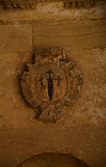 Detail of heraldic shield of the order of Calatrava on the facade of a church in the town of 