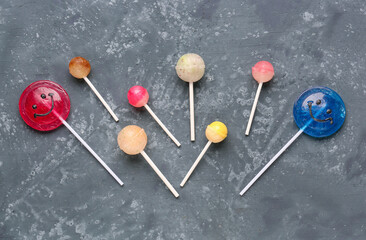 Composition with sweet lollipops on grey grunge table