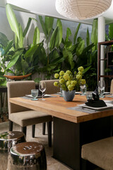 Massive wooden dining table with beautiful flower centerpiece on the balcony