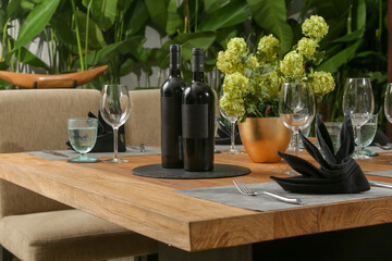 Massive wooden dining table with beautiful flower centerpiece on the balcony