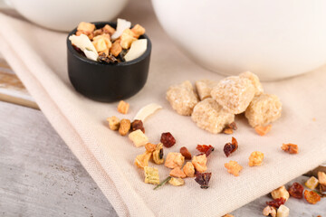 Napkin with dried fruit tea and snacks on white wooden table
