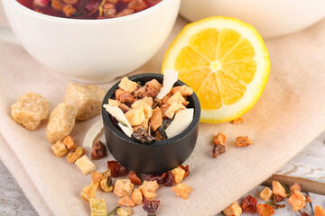 Napkin with dried fruit tea, lemon and snacks, closeup