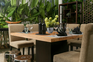 Massive wooden dining table with beautiful flower centerpiece on the balcony