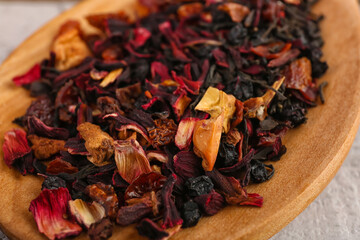 Wooden spoon with dried fruit tea, closeup