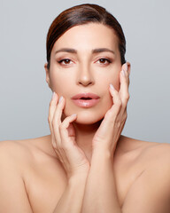 Ecologic Makeup and Skincare Concept. Sensual serene woman with nude organic makeup on a luminous flawless skin