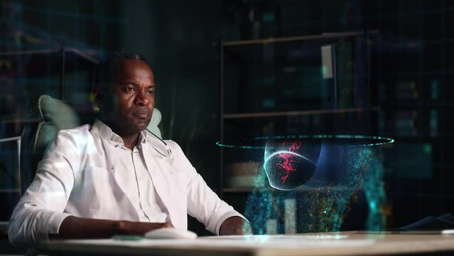 Portrait of focused mature african american doctor looks at hologram of the lungs of patient with an inflammatory process using augmented reality indoors Virus 3d animation Futuristic digital concept