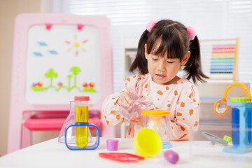 young girl plays science experiment for home schooling