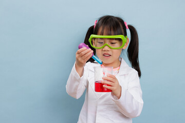 young  girl pretend play scientist role at home against plain background