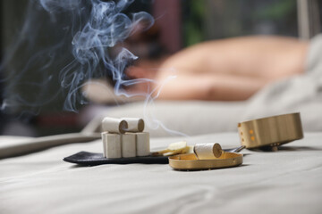Moxibustion treatment - traditional Chinese medicine tools for acupuncture points heating therapy.
Chinese herbal medicine. Moxibustion copper burner box with moxa herbal sticks in holistic spa. 