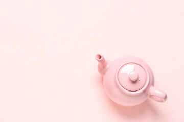Ceramic teapot on pink background