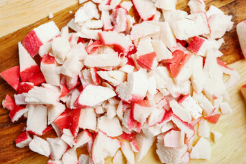Tasty chopped crab sticks on table, closeup © Pixel-Shot