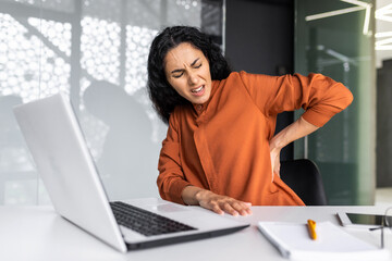 Office worker Latin American business reaper is sick at the workplace, an overtired businesswoman...