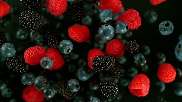 Super Slow Motion Shot of Flying and Rotating Fresh Blueberries, Blackberries and Raspberries at 1000fps.
