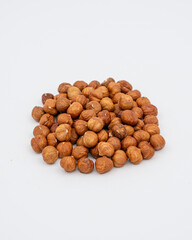 Peeled hazelnuts on a white background
