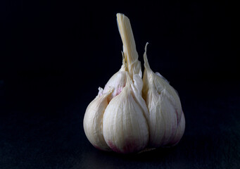 juicy garlic on black background