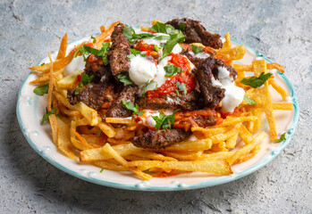 Turkish food; Cokertme Kebab - Beef meat kebab with yoghurt and french fries
