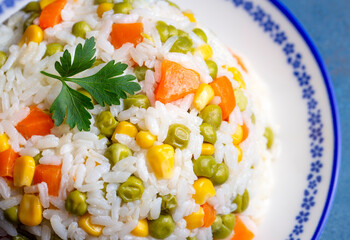 Delicious vegetable rice pilaf with green peas, carrots and sweet corn (Turkish name; sebzeli pilav)