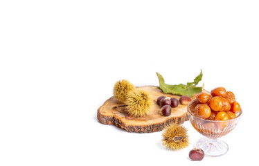 Chestnut dessert and chestnuts on a plate. Traditional delicious Turkish dessert; chestnut candies (Kestane Sekeri)