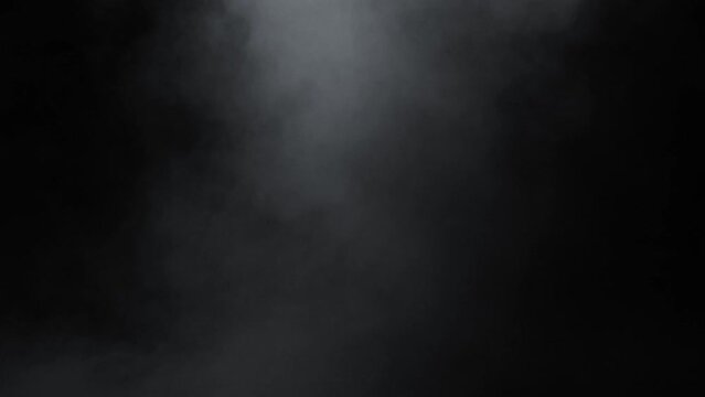 Smoke. Cloud of cold fog in blue light spot on black background. Abstract white smoke in slow motion. Light, white, fog, cloud, abstract, smoke, black, background, 4k, ice smoke cloud. Floating fog.	