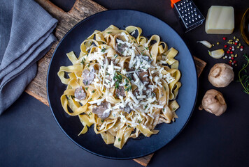 Homemade Italian fettuccine pasta (Fettuccine al Funghi Porcini) with mushroom and cream sauce. Traditional Italian cuisine.