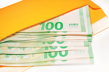 Bundle of money 100 euro bills in an envelope