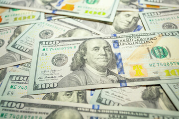 100 dollar banknote Benjamin Franklin against the background of other dollars bills