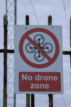 no drone warning sign next to airport navigation NDB beacon