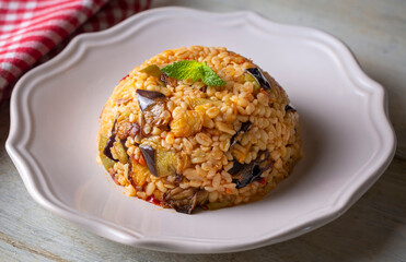 Traditional delicious Turkish food; Bulgur pilaf with eggplant and vegetables. (Turkish name; Patlicanli bulgur pilavi)