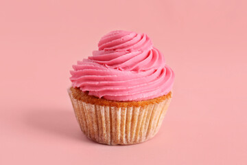 Tasty cupcake on pink background