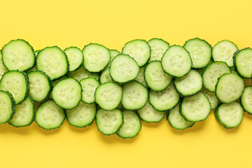 Slices of cucumber on yellow background