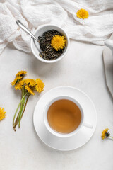 Obraz na płótnie Canvas Cup of healthy dandelion tea on white background