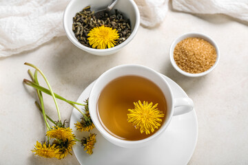 Cup of healthy dandelion tea on white background