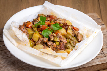 Traditional Turkish food; Meat with vegetables wrapped in greaseproof paper, kebab (Turkish name; Sebzeli kagit kebabi)