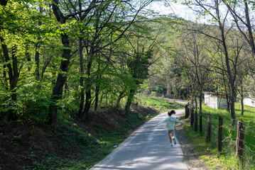 Child joyofully running down the hill 