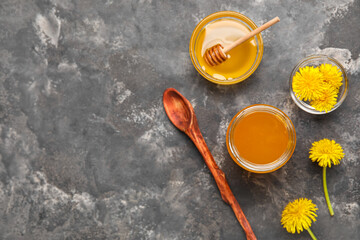 Obraz na płótnie Canvas Jar and bowl with dandelion honey on dark grunge background