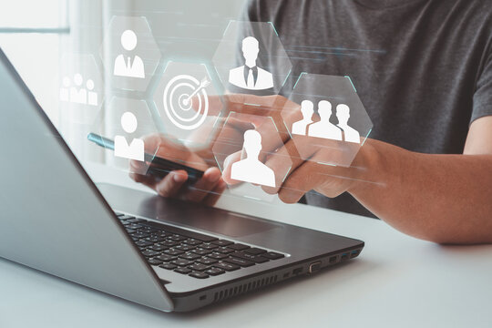 Target audience concept. Businessman click on target button on virtual screen to focus customer group. Marketing plan and strategies. Personalization marketing, customer centric strategies.