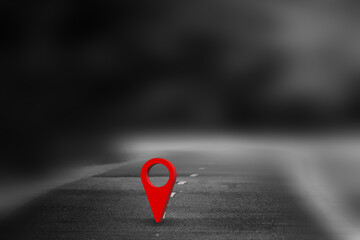 Red GPS pin on the asphalt road and nature landscape