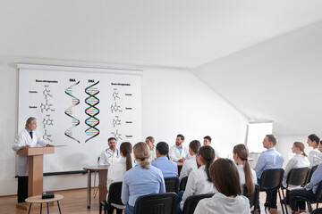 Lecture about difference between RNA and DNA. Professors and audience in conference room....