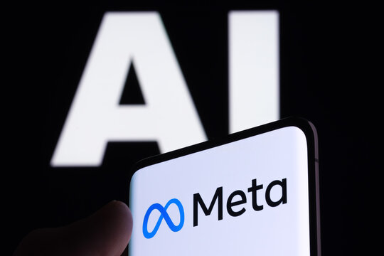 Meta logo seen on smartphone and AI letters on the background. Concept for Meta Facebook Artificial Intelligence. Stafford, UK, May 2, 2023