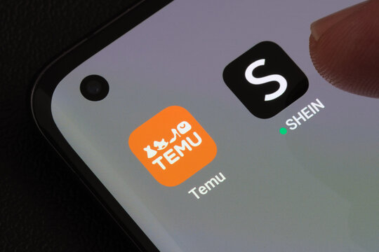 TEMU and SHEIN apps seen on the screen of smartphone. Temu app and Shein app are chinese budget shopping platforms. Stafford, United Kindom, May 2, 2023