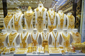 Dubai gold souk market window with jewellery, necklaces, dress and luxury accessories. DUBAI, UNITED ARAB EMIRATES - April, 2023