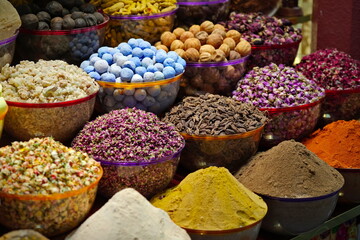 Variety of spices and dried herbs flowers on the arab street market stall. Dubai Spice Souk in Deira, United Arab Emirates.