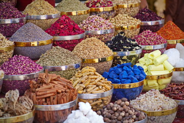 Variety of spices and dried herbs flowers on the arab street market stall. Dubai Spice Souk in Deira, United Arab Emirates.