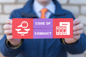 Code of conduct business concept on colorful blocks in businessman hands. Ethics and respect in...