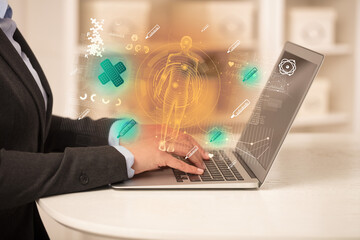 Doctor working on laptop with healthcare concept