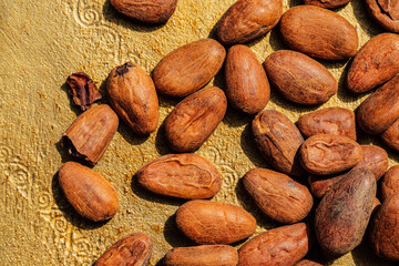 brown cacao, cocoa beans on golden background
