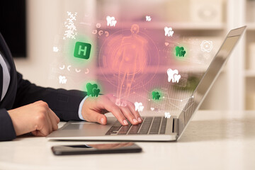 Doctor working on laptop with healthcare concept